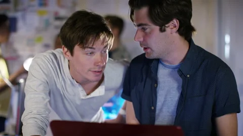 4K Group of young male computer programmers working together in small office Stock Footage 54430097