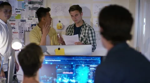 4K Group of young male computer programmers working together in small office Stock Footage 54430960