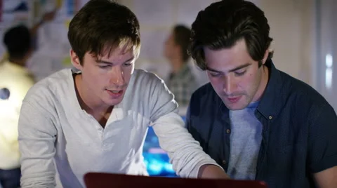 4K Group of young male computer programmers working together in small office Stock Footage 54431233