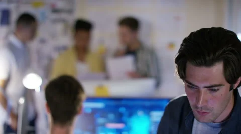 4K Group of young male computer programmers working together in small office Stock Footage 54432040