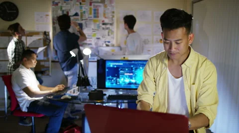 4K Group of young male computer programmers working together in small office Stock Footage 54435201