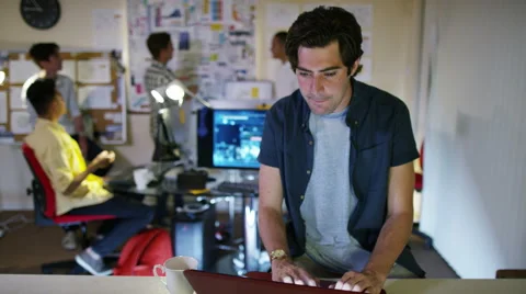 4K Group of young male computer programmers working together in small office Stock Footage 54438693