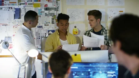 4K Group of young male computer programmers working together in small office Stock Footage 54440920