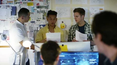 4K Group of young male computer programmers working together in small office Stock Footage 54440954