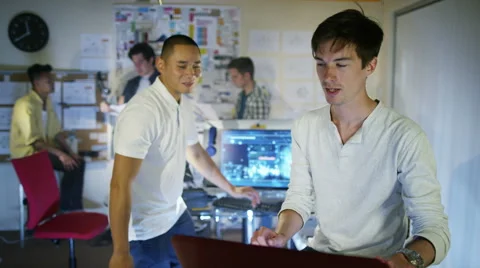 4K Group of young male computer programmers working together in small office Stock Footage 54443874