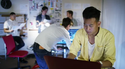 4K Group of young male computer programmers working together in small office Stock Footage 54445811