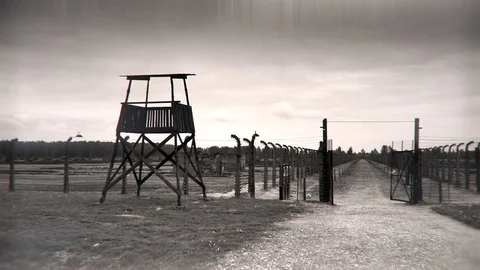 4K Guard Tower Along Barbed Wire Fence, Auschwitz Barracks  Stock Footage 83972978