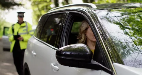 4K Guilty driver trying to make excuses to policeman after being pulled over Stock Footage 113137485