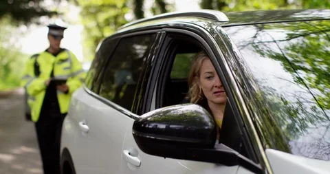 4K Guilty woman driver trying to talk her way out of a ticket from traffic cop Stock Footage 113135237