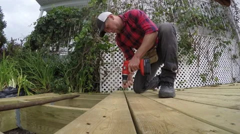 4k guy screws deck together Stock Footage 51739495