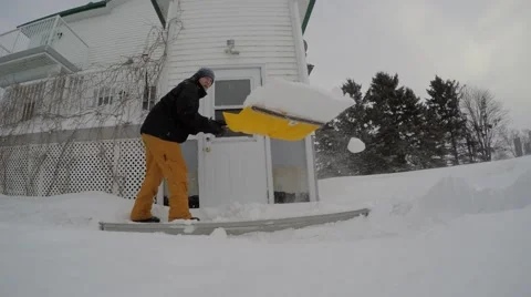 4k guy shovelling throws snow on camera Stock Footage 46498672