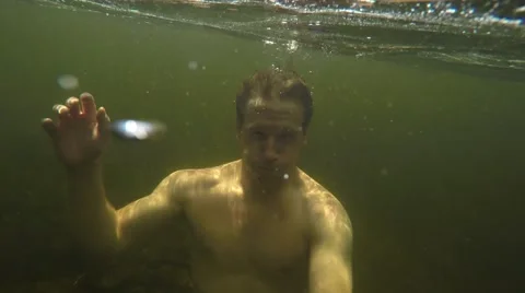 4k guy under water in stream Stock Footage 50973297