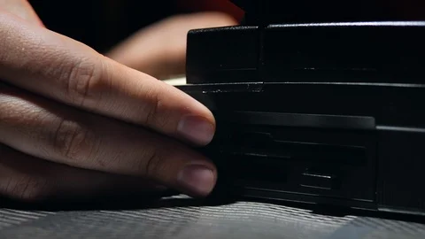 4k Hacker man works with old retro laptop at dark room with floppy disc hands Stock Footage 87182734