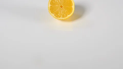 4k half a lemon, Bright yellow citrus fruit on white background Stock Footage 90187521