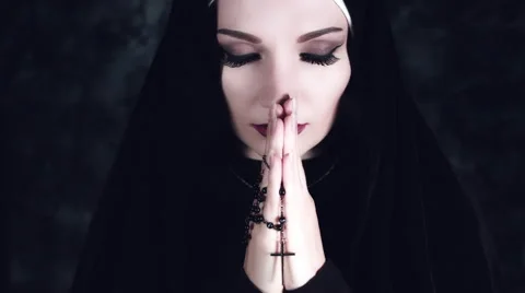 4k Halloween Shot of a Horror Nun Praying with Cross Stock Footage