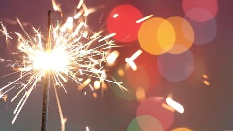 4K Hand-Held Burning Sparkler Emitting Sparks Colorful Festive Bokeh Stock-Footage 334440633