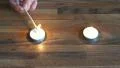 4K hand lighting white tealight candles with a flame from a long wooden match 4k or 4k+ Resolution