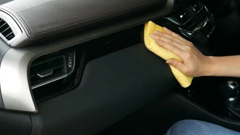 4k of hand with microfiber cloth cleaning a car console Video stock 94533653