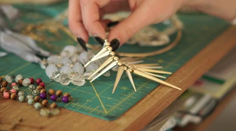 4K hand picking up, choosing beaded necklaces Stock Footage 59799287