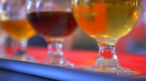 4K Hand Picks Up Beer Taster Glass, Macro Shot of Flight of Craft Pub Beer Stock Footage 67978687