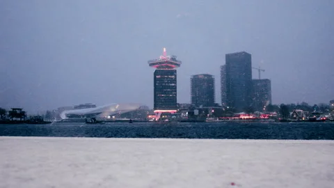 4K Handheld View of Amsterdam Noord Skyline in Snow from Central Station at Dawn Stock Footage 338429482