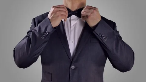 4K Hands Fixing Black Bow Tie, White Background, Ceremony Black Suit, Tuxedo Stock Footage 72374950