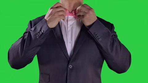 4K Hands Fixing Pink Bow Tie, Green Screen Background, Ceremony Black Suit Video stock 72375232