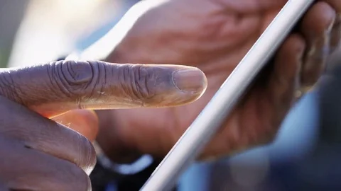 4K Hands of a senior african american business man using a tablet device outdoor Stock Footage