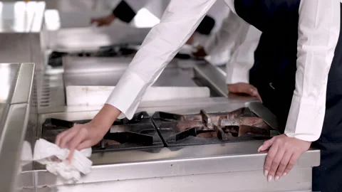 4K Hands of trainee chef cleaning kitchen after finished cooking food in re.. Stock Footage 245134131