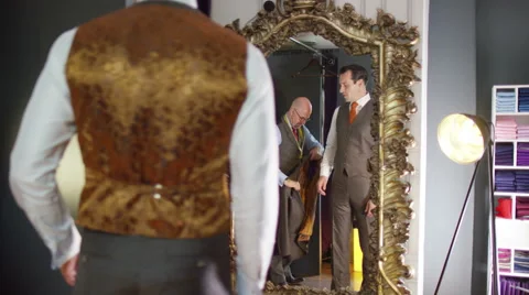 4K Handsome man trying on a new suit in tailor's shop Stock Footage 63224846