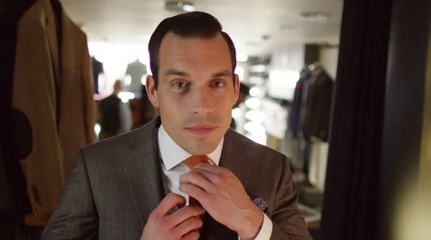 4K Handsome man trying on a new suit in tailor's shop. Stock Footage 63235551