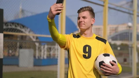 4K Handsome Young Man Taking a Photo. Selfie With Soccer Ball Near The Goal Stock Footage 152080147