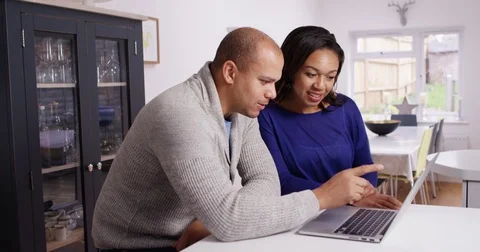 4K Happy couple relaxing at home looking at laptop computer. Stock Footage
