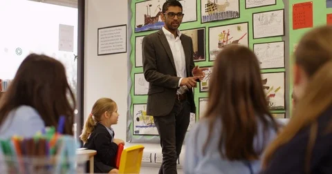 4K Happy elementary school teacher talking to his class & asking questions Stock Footage