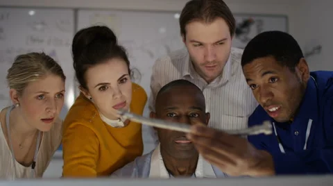 4K Happy engineering team working together, looking at computer screen 스톡 동영상 63319546