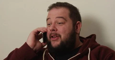 4K Happy extrovert overweight man talking to a friend on the phone 스톡 동영상 74308452