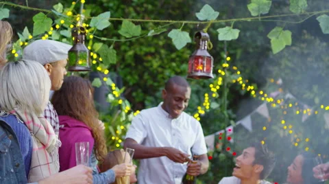 4K Happy group of friends at outdoor social gathering, one man pours champagne Stock Footage