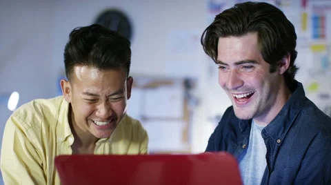 4K Happy male computer programmers working together give a high five Stock Footage 54470912