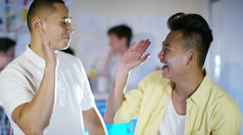 4K Happy male computer programmers working together give a high five Stock Footage 54472628