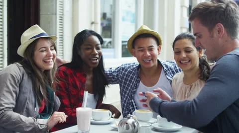 4k Happy mixed ethnicity group of friends pose for photo at outdoor cafe Stock Footage