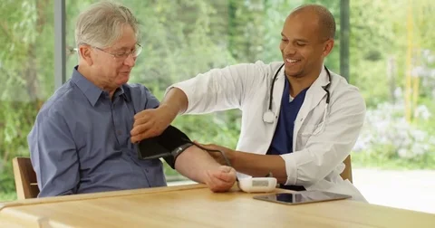 4K Happy senior man getting a check up with friendly doctor in his office Stock Footage 81254738
