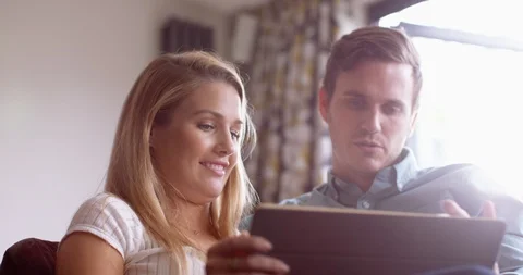 4K Happy smiling couple browsing &amp; swiping on touchscreen computer Video stock 114763894