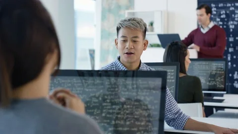 4K Happy students working on computers &amp; chatting in math class Stock Footage 73183060