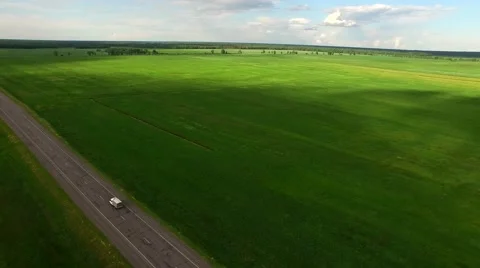 4K HD Flying above van car moving green valley field landscape on two lane road Stock Footage 63501147