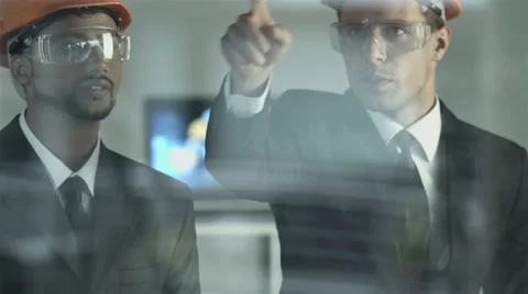 4K &amp; HD resolutions: the builders discussing the project by the glass screen Video stock 39307795