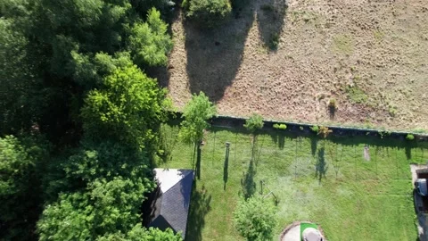 4k. Head-over shoot of man in plot a and house in the middle of the nature Stock Footage 235209408