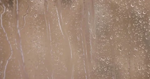 4k heavy Rain Drops Falling down on window glass Stock Footage 261298060