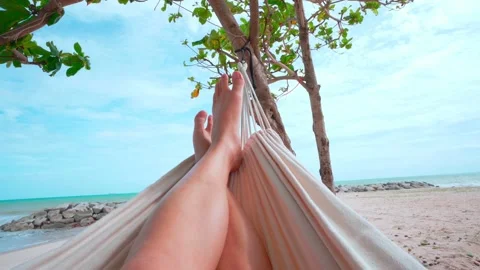 4k Hello Summer man relaxing in hammock tanning on the beach Stock Footage 157906805