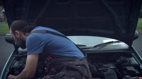4K Hi-Tech Shot of a Mechanic Man Fixing his car and Looking at Camera Stock Footage 68594780