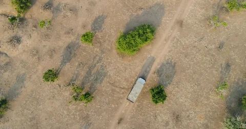 4K High aerial straight down view of a 4x4 safari vehicle driving  thorugh the Stock Footage 102753555